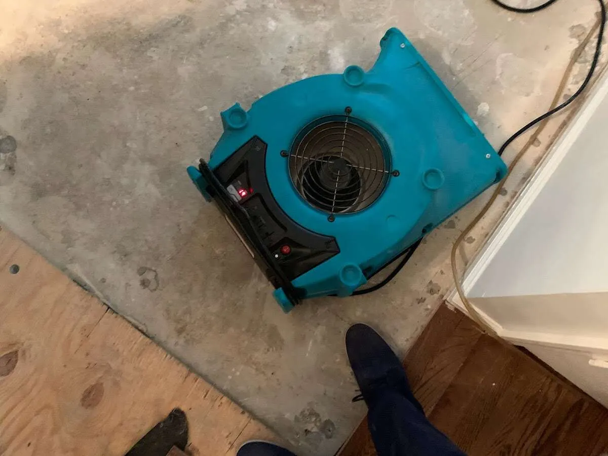 Air mover drying subfloor during Commercial Water Damage Restoration in Bedford Heights